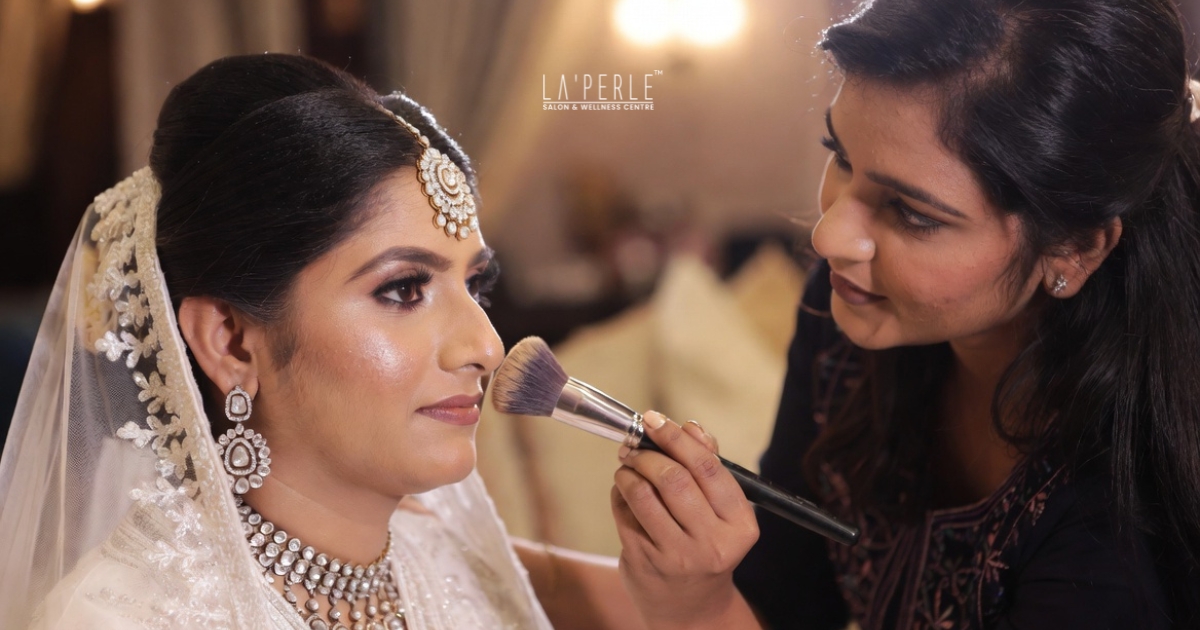 Indian bride with flawless glowing skin after HD bridal makeup foundation application.