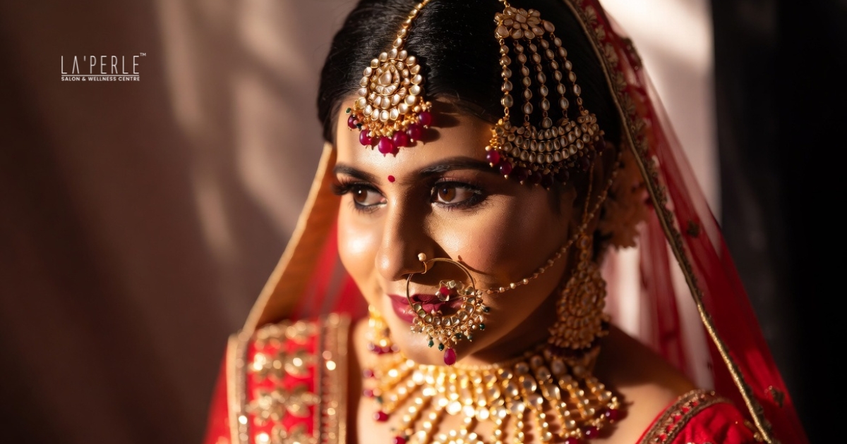 Professional makeup artist blending long-lasting foundation during bridal makeup preparation.